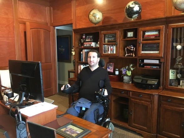 Photo of Scott Fedor, Vice President of LEAP's board, sitting behind his desk at his office.